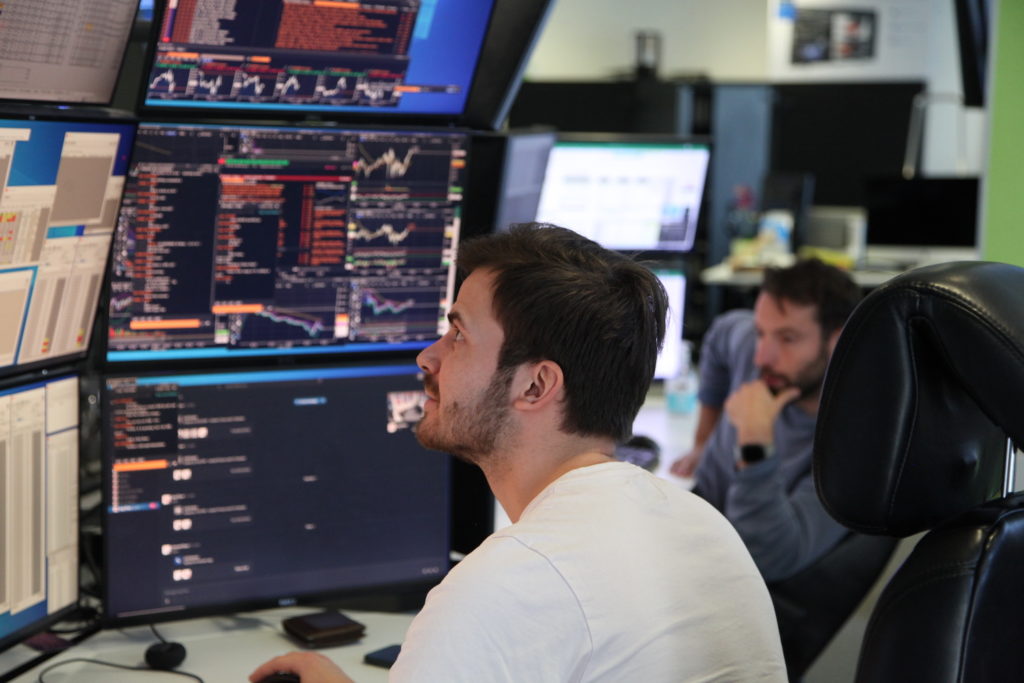 A UTR8 trader watching pricing screens at the desk