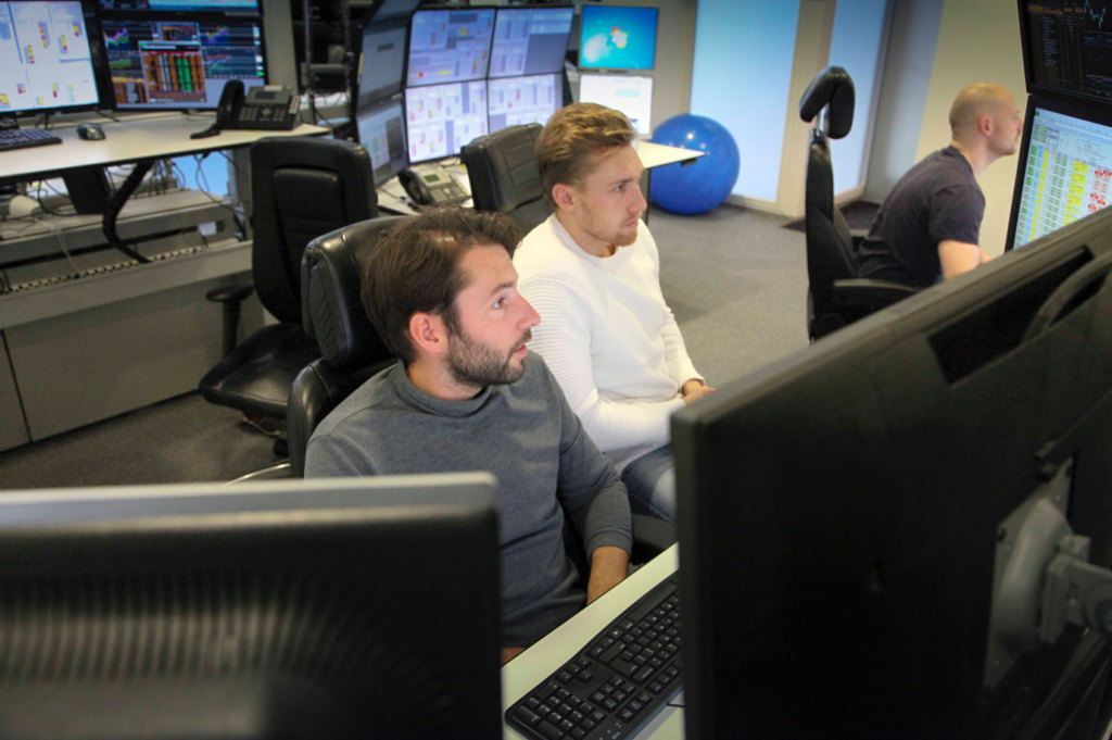 Traders at multi-screen desks on the UTR8 trading floor